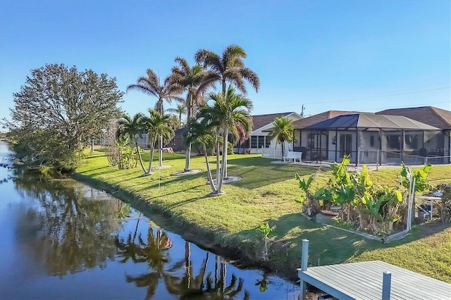 view of community with a lawn and a water view