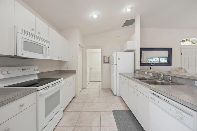 kitchen featuring white appliances, vaulted ceiling, sink, light tile patterned floors, and white cabinetry