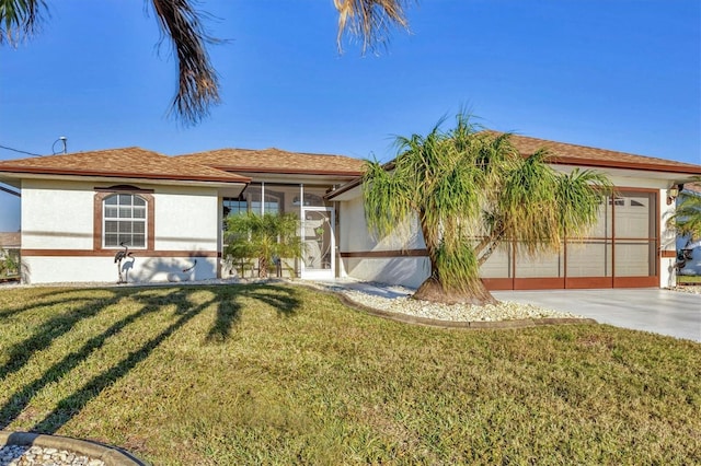 view of front of home with a front lawn and a garage