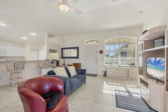 tiled living room featuring ceiling fan