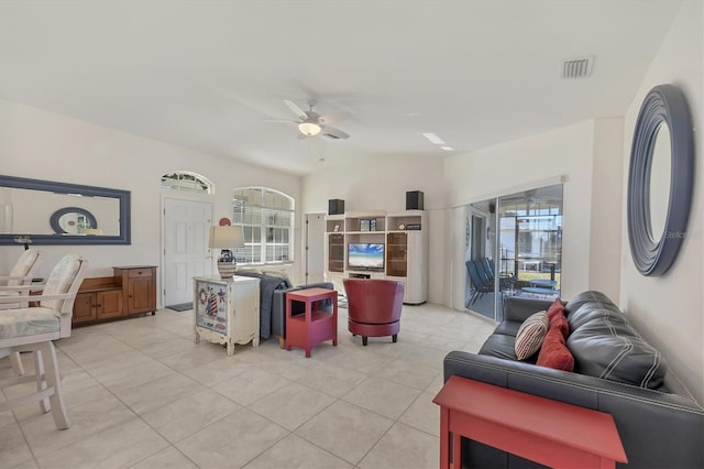 tiled living room with ceiling fan