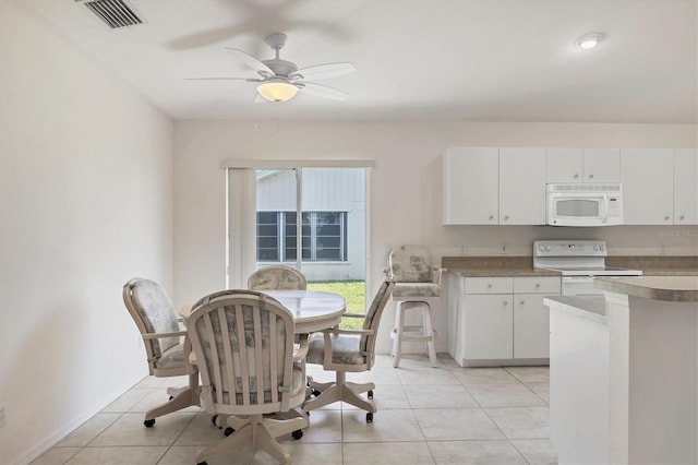 kitchen featuring white cabinets, light tile patterned floors, white appliances, and ceiling fan