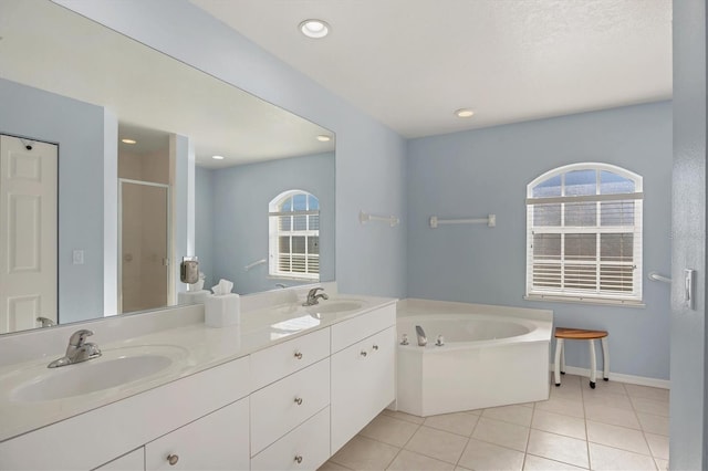 bathroom with tile patterned floors, vanity, and independent shower and bath