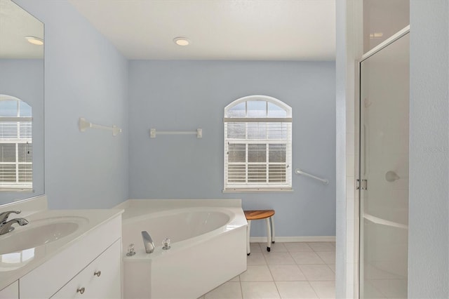 bathroom with tile patterned flooring, vanity, and shower with separate bathtub