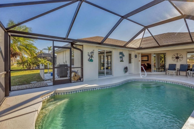 view of swimming pool featuring a lanai and a patio area