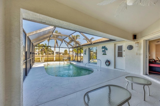 view of swimming pool featuring a lanai and a patio