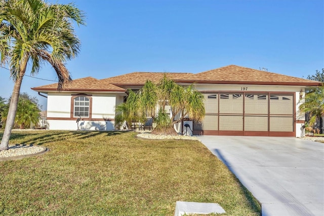 view of front of house with a front lawn and a garage