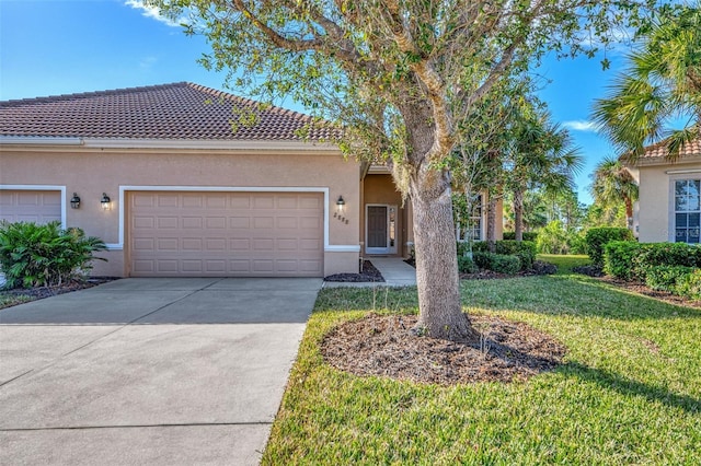 mediterranean / spanish home with a garage and a front yard