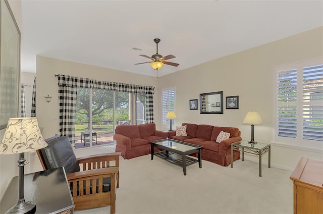 living room featuring light colored carpet and ceiling fan