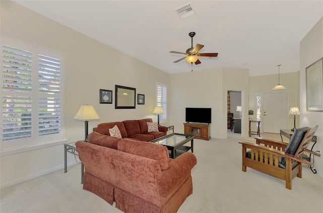 carpeted living room featuring ceiling fan