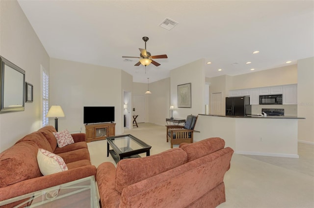 carpeted living room with ceiling fan