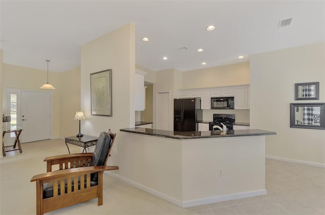 kitchen featuring black appliances, hanging light fixtures, dark stone countertops, kitchen peninsula, and white cabinets