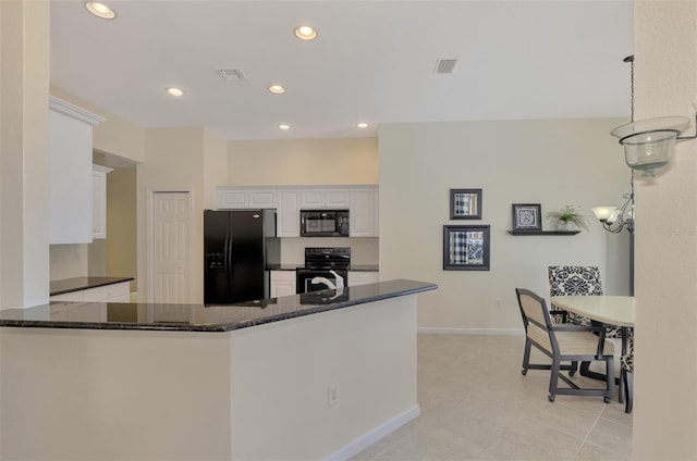 kitchen with white cabinets, dark stone counters, kitchen peninsula, and black appliances