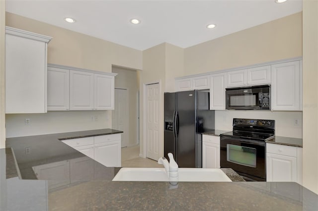 kitchen featuring white cabinets, sink, and black appliances