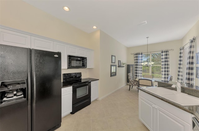 kitchen featuring pendant lighting, white cabinetry, sink, black appliances, and an inviting chandelier