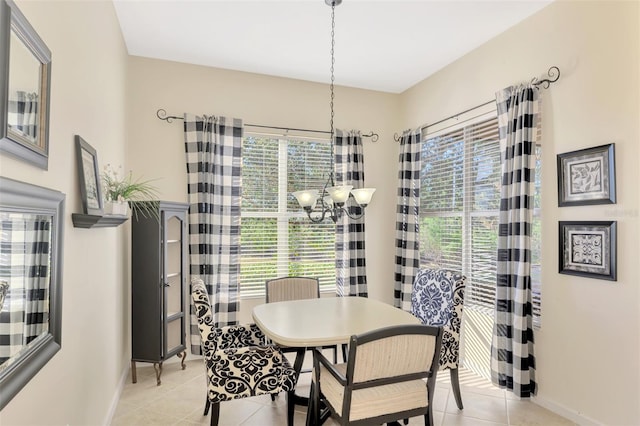 dining space featuring light tile patterned floors and a chandelier