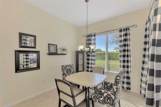 dining area with an inviting chandelier, a wealth of natural light, and light tile patterned flooring