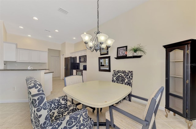 tiled dining room featuring an inviting chandelier