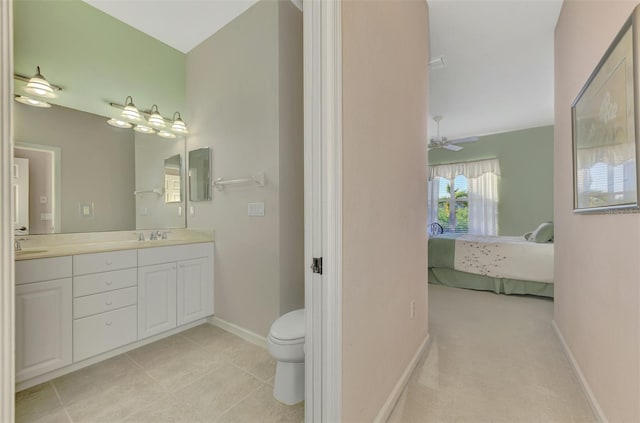 bathroom featuring vanity, ceiling fan, and toilet