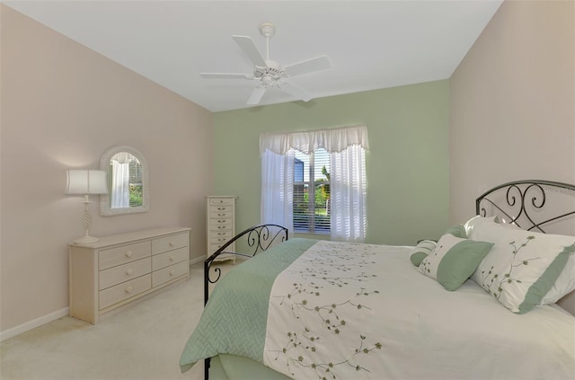 bedroom featuring light carpet and ceiling fan