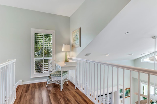 interior space featuring dark hardwood / wood-style flooring and vaulted ceiling