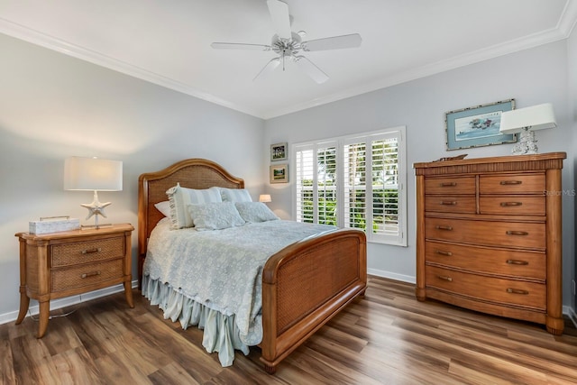 bedroom featuring ornamental molding, ceiling fan, and dark wood-type flooring