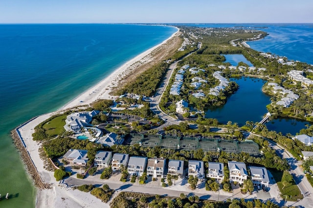 bird's eye view featuring a water view and a beach view