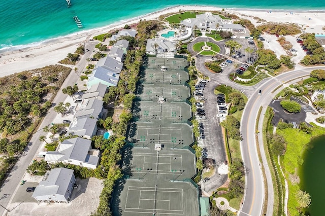 birds eye view of property with a beach view and a water view