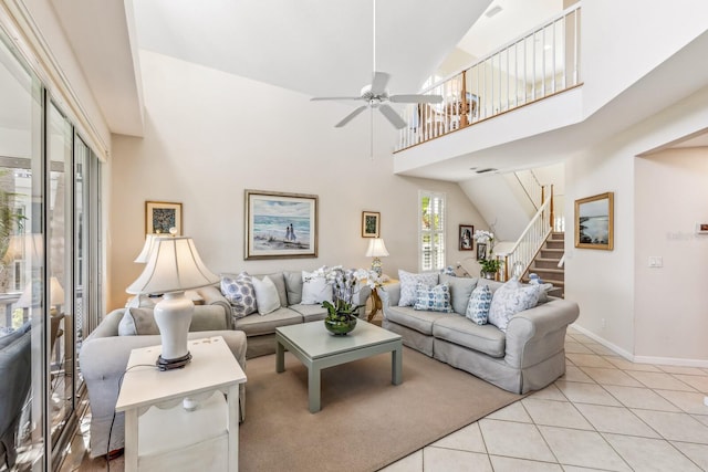 tiled living room with a towering ceiling and ceiling fan