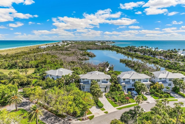 drone / aerial view featuring a water view and a view of the beach