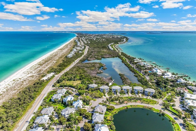 bird's eye view featuring a water view and a beach view