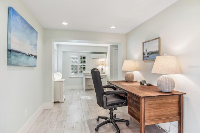 office with a wall unit AC and light wood-type flooring