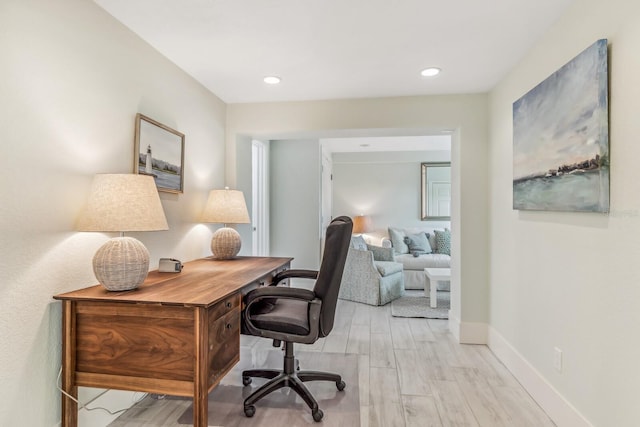 home office with light hardwood / wood-style floors