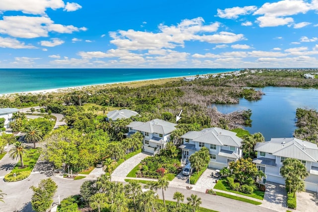 drone / aerial view with a beach view and a water view