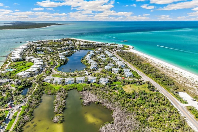 drone / aerial view with a beach view and a water view