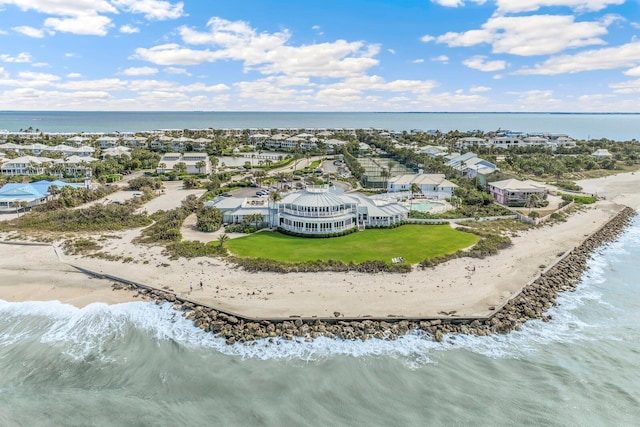 bird's eye view featuring a water view and a beach view