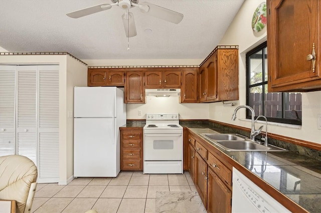 kitchen featuring ceiling fan, sink, a textured ceiling, white appliances, and light tile patterned floors