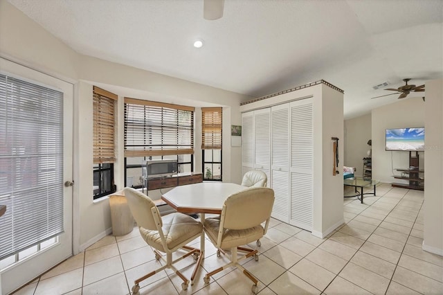 tiled dining area featuring a textured ceiling, ceiling fan, plenty of natural light, and lofted ceiling