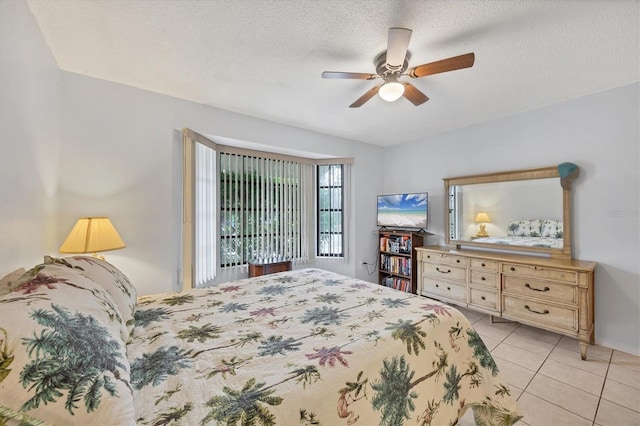 tiled bedroom featuring a textured ceiling and ceiling fan