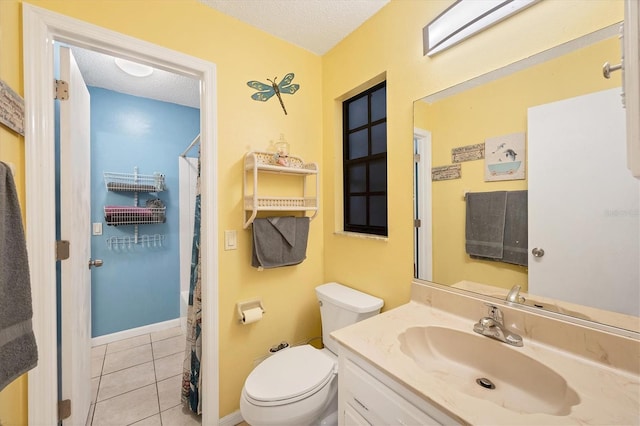 bathroom featuring tile patterned flooring, vanity, toilet, and a textured ceiling