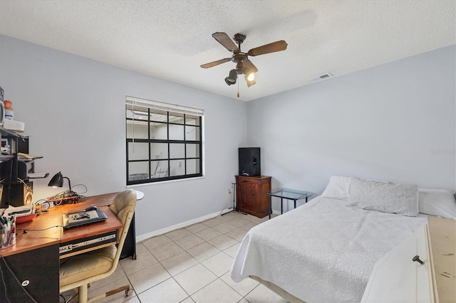 tiled bedroom featuring ceiling fan and a textured ceiling