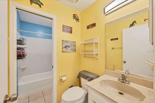 full bathroom with vanity, a textured ceiling, tile patterned flooring, toilet, and tiled shower / bath