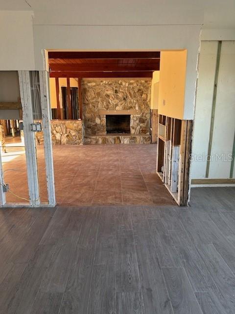 unfurnished living room with dark wood-type flooring and a fireplace