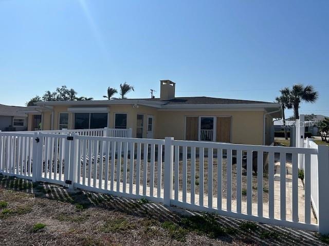 view of front facade featuring fence and stucco siding