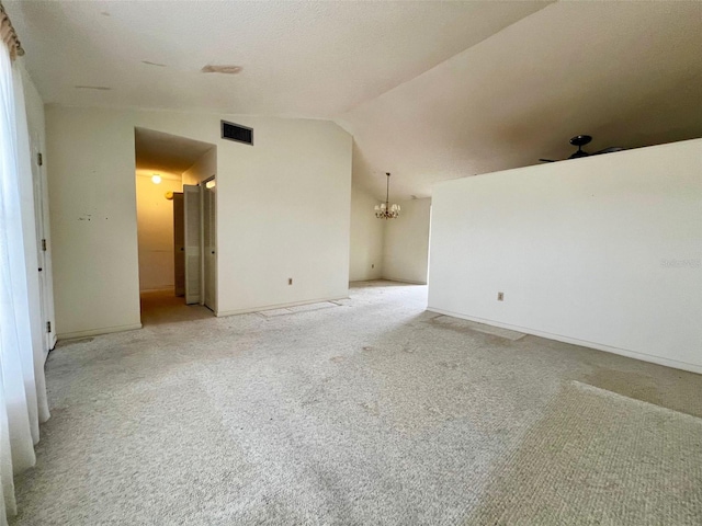 empty room with ceiling fan, light colored carpet, and lofted ceiling