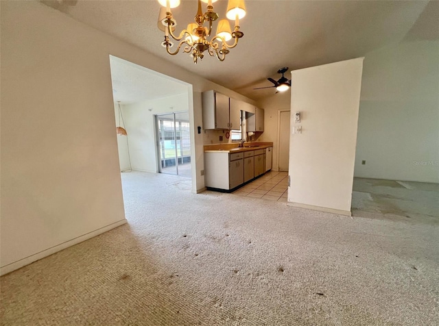 unfurnished living room featuring sink, light colored carpet, and ceiling fan with notable chandelier