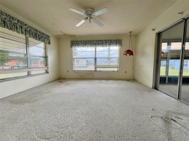 spare room featuring ceiling fan and a textured ceiling