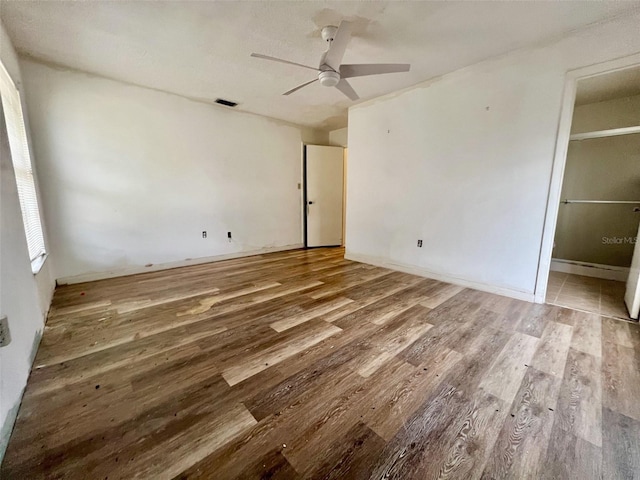 unfurnished bedroom with ceiling fan and wood-type flooring