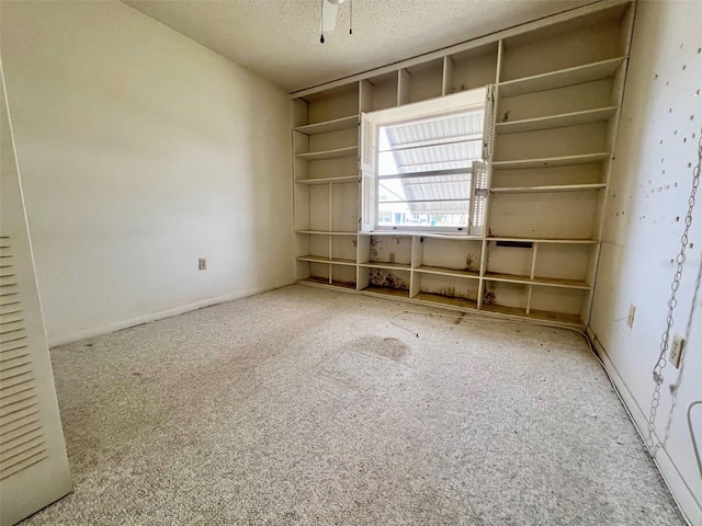 carpeted spare room featuring a textured ceiling