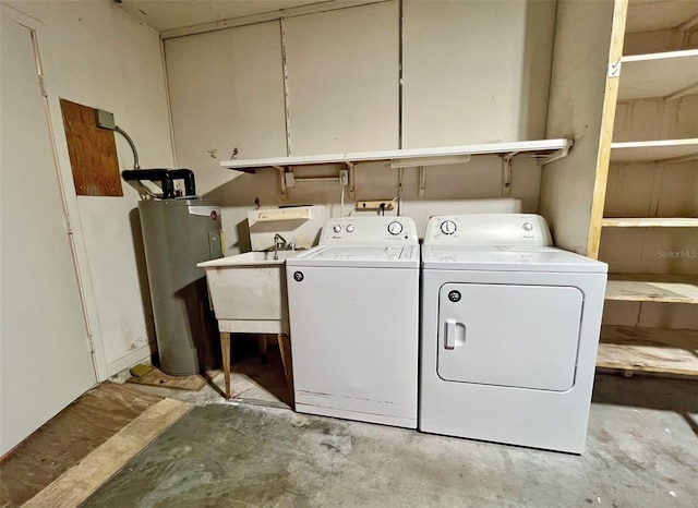 laundry area featuring washer and clothes dryer, gas water heater, and sink